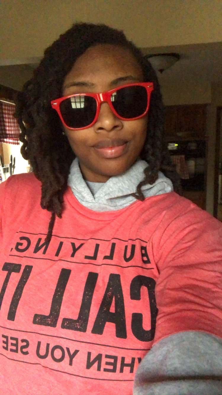 A woman from Banneker Elementary wearing sunglasses during Bully Awareness Spirit Week